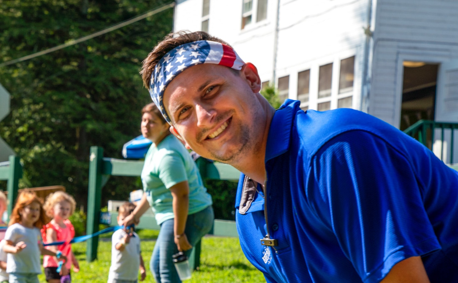 Jay with an American flag headband leading a team.