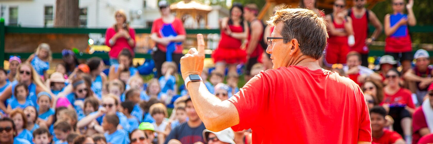 Camp staff speaking at a camp assembly.