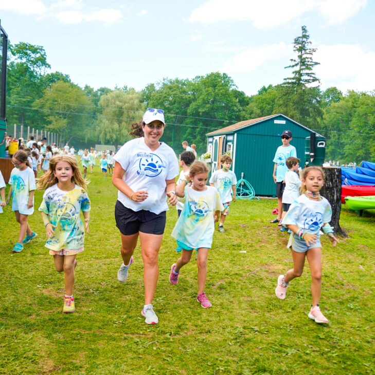 Campers running and smiling.
