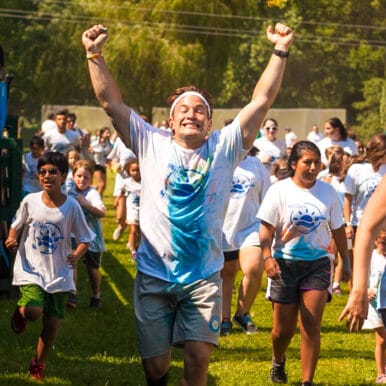 A camper running with his hands in the air