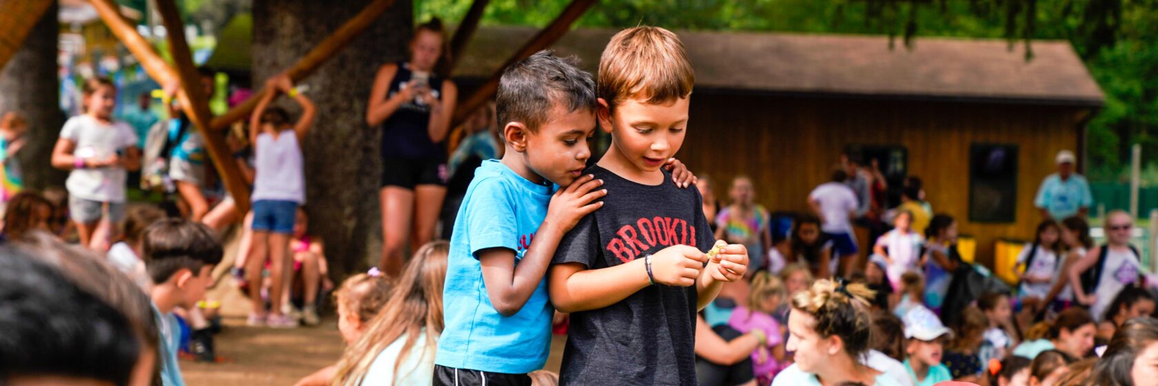 Two campers standing at a camp assembly.
