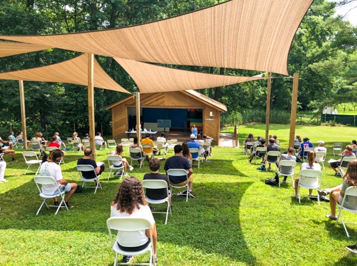 Campers sitting in chairs and watching a presentation.