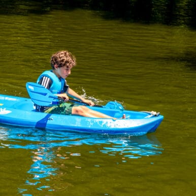 A camper kayaking.